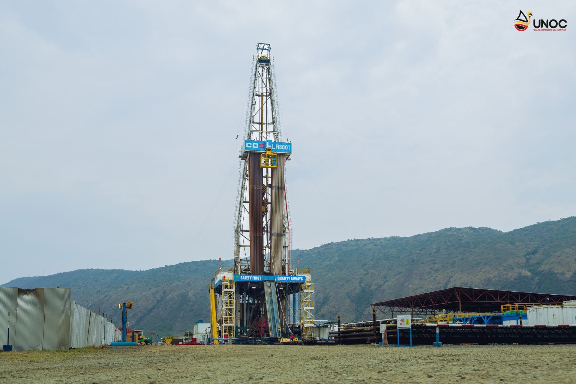 Drilling rig operating against the Kabalega escarpment
